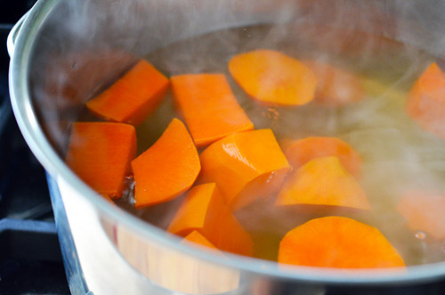 Boiling pieces of sweet potato.