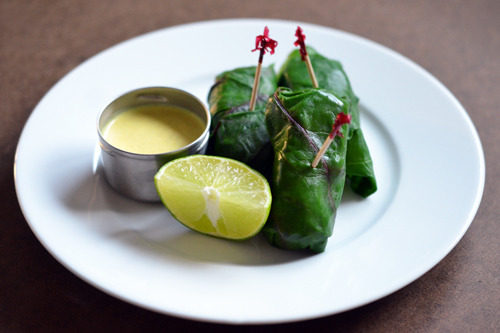 A plate of lamb dosas with a side of coconut crème.