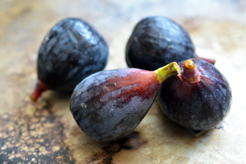 Four figs on a countertop.