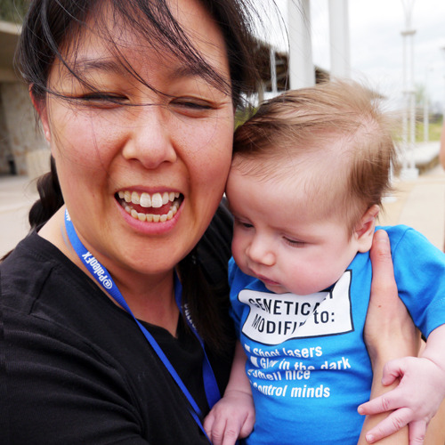 Michelle Tam smiling while holding a baby.