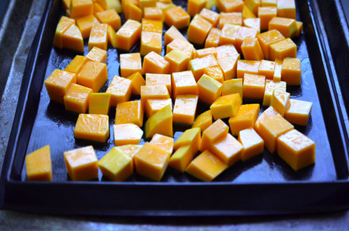 Cubed butternut squash on a sheet pan.