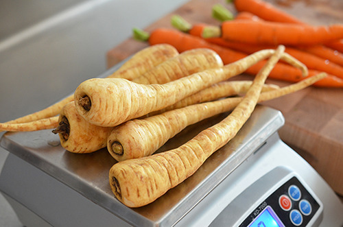 Weighing out the parsnips on a scale for Roasted Garlic Autumn Root Vegetable Mash.
