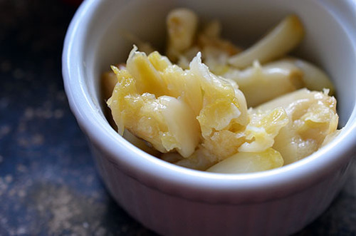 Smashed roasted garlic in a small ramekin.