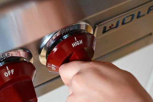 A closeup of a red stovetop dial set on High.