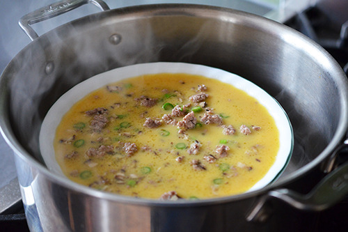 An overhead shot of Cantonese Egg Custard with Minced Pork inside an open pot.