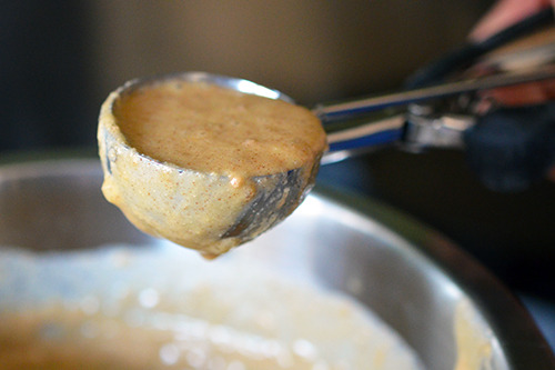 A disher scoops out the paleo pancake batter.