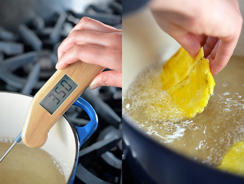 The frying oil temperature at 350 degrees and someone laying in the smashed pieces of fried plantain into the oil.