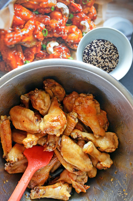 Cooked chicken wings in a metal bowl.