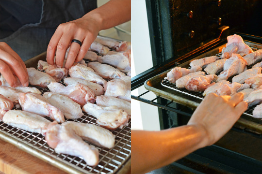Someone arranging raw chicken on a wire rack and putting them into the oven to bake,