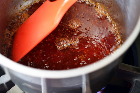 Reducing the sauce on the stove for Sticky Seseame Teriyaki Chicken Wings.