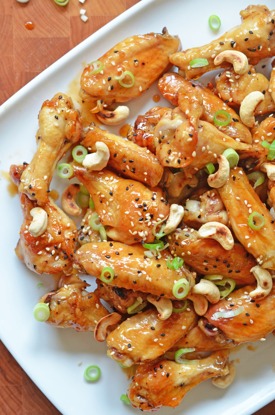 Paleo Sticky Seseame Teriyaki Chicken Wings piled on a white plate.