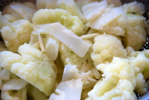 Steamed cauliflower draining in a colander