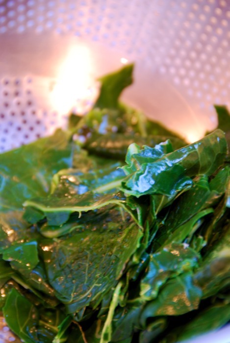 Tasty and pretty collard greens sitting in a colander.