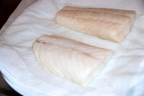 Dried off Alaskan cod fillets on paper towels.