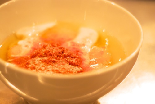 A bowl containing eggs, coconut milk, curry powder, salt, pepper, and parsley for a paleo and whole30 recipe.