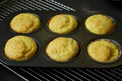 Baked cheesy egg muffins in their muffin tin.