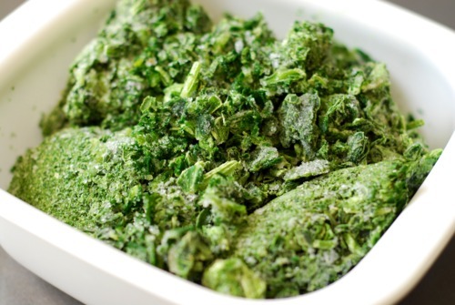 A package of frozen spinach in a bowl.