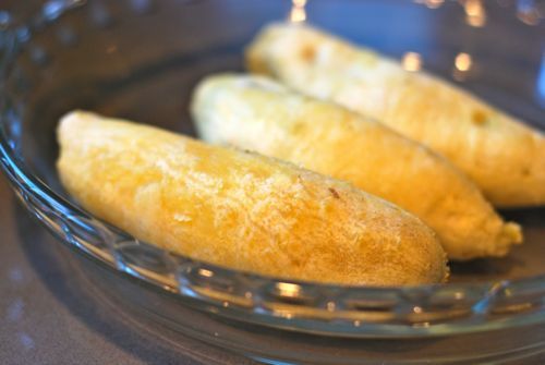 Peeled and ready to eat microwaved yams in a shallow glass bowl.