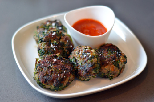A plate beef, spinach and mushroom mini burgers on a plate with a small bowl of Rao's sauce.