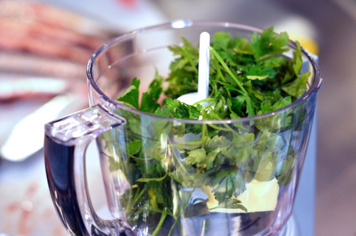 All the ingredients for the herb-stuffing in a food processor for broiled herb-stuffed sardines.