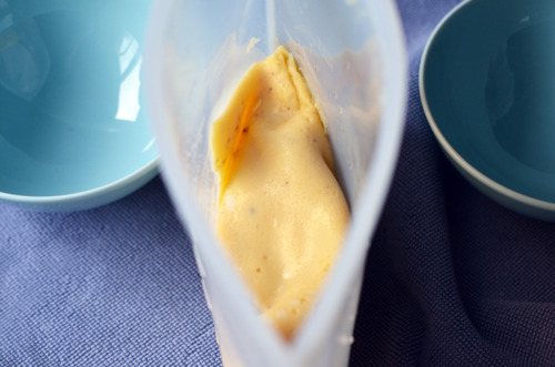 An opened sous vide bag with cooked scrambled eggs inside.