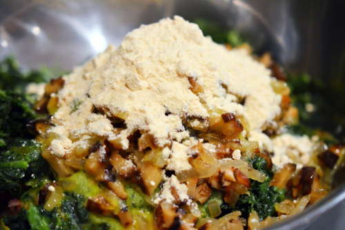 Coconut flour is added to the bowl with the pork slider ingredients. 