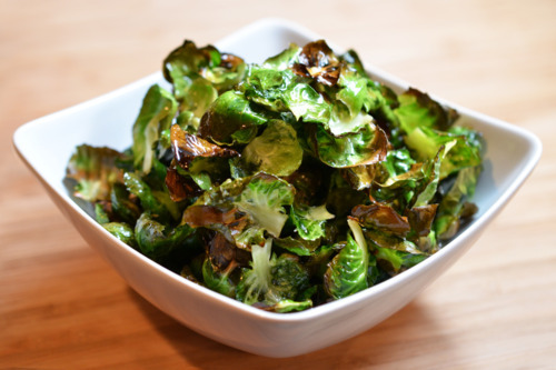 A bowl of baked brussels sprouts chips.