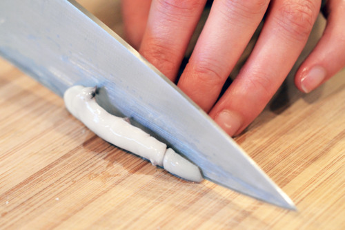 Thinly slicing the flash grilled squid for grilled calamari.