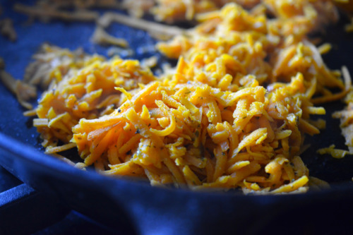 A closeup of Sweet Potato Hash in a cast iron skillet.