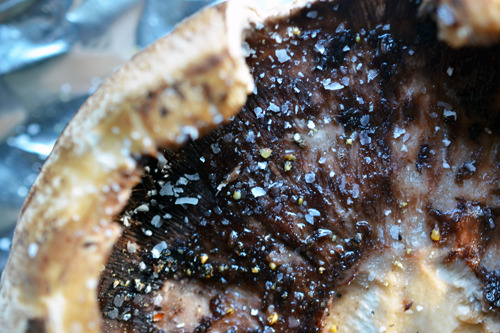 A closeup overhead shot of a portobello mushroom gill-side up, ready for the oven.