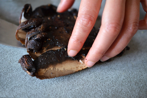 Someone slicing up Roasted Portobello Mushrooms 