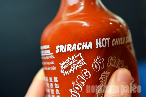 A closeup of a plastic squeeze bottle of Huy Fong's Sriracha