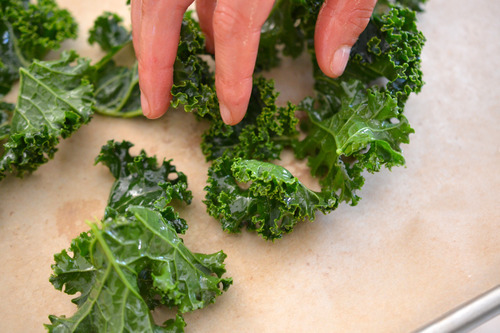 When you make baked kale chips, line a baking sheet with parchment paper and lay some of the leaves on top in a single layer.