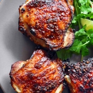 An overhead shot of Vietnamese Lemongrass Chicken on a plate with herbs.